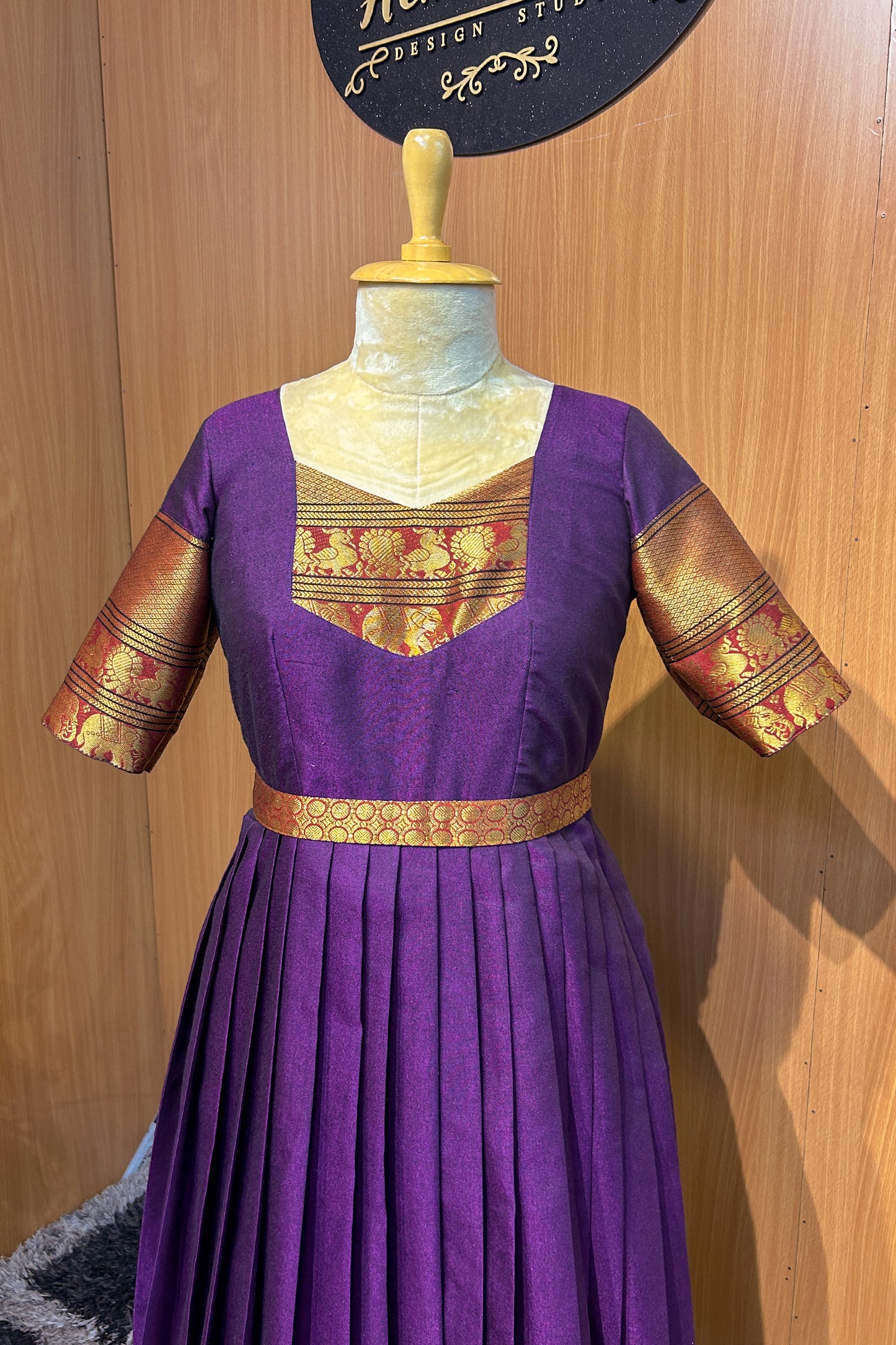 The rich purple silk fabric is accentuated with golden zari borders on the sleeves and hem, adding a luxurious ethnic charm. The pleated skirt enhances the flow and fall of the gown, while the fitted waist yoke offers a flattering silhouette. A perfect choice for women who love traditional attire with a designer twist.
Key Features:
💜 Color: Royal Purple with Gold Zari Accents
🧵 Fabric: Premium Silk Blend with lining
✂️ Design: Fitted Waist Yoke | Knife Pleats | Elbow Sleeves