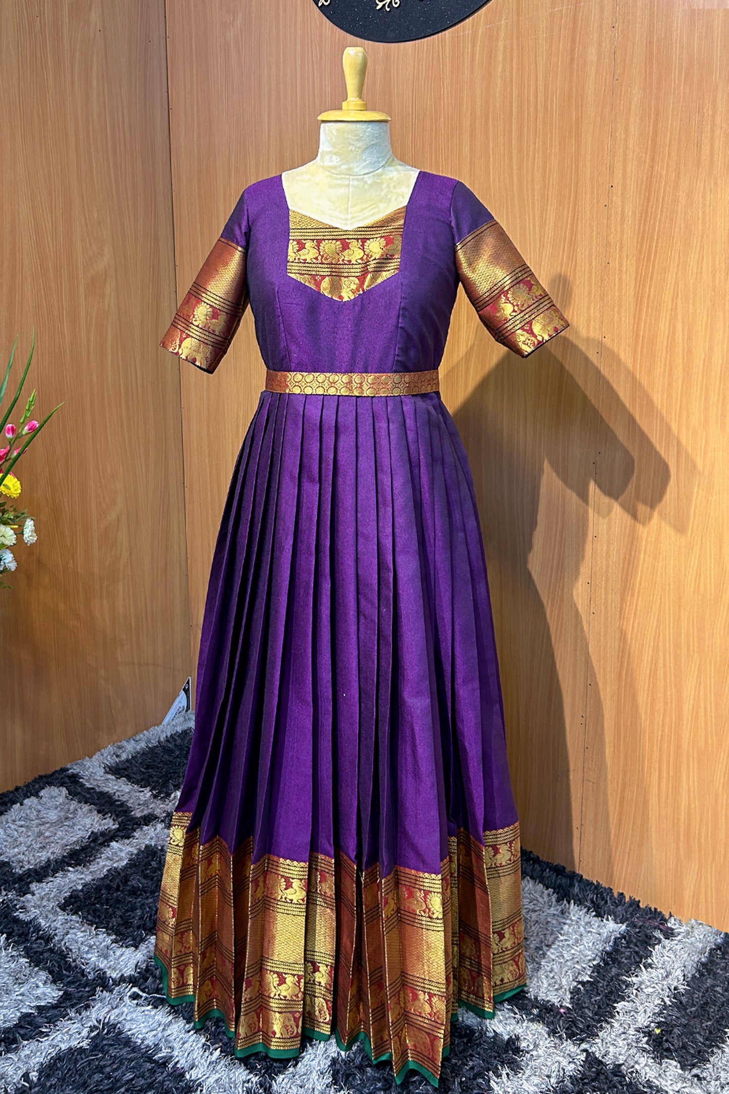 The rich purple silk fabric is accentuated with golden zari borders on the sleeves and hem, adding a luxurious ethnic charm. The pleated skirt enhances the flow and fall of the gown, while the fitted waist yoke offers a flattering silhouette. A perfect choice for women who love traditional attire with a designer twist.
Key Features:
💜 Color: Royal Purple with Gold Zari Accents
🧵 Fabric: Premium Silk Blend with lining
✂️ Design: Fitted Waist Yoke | Knife Pleats | Elbow Sleeves