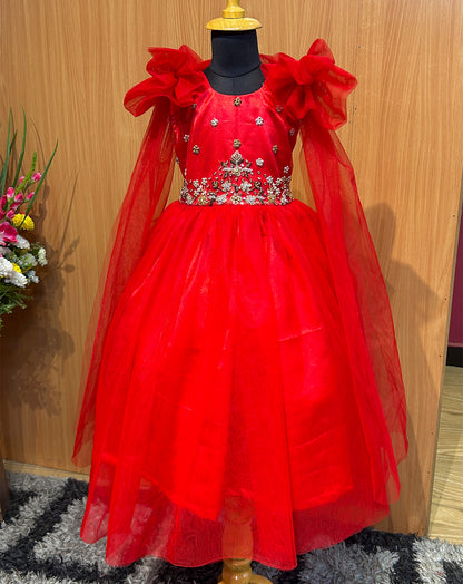Ignite your baby's wardrobe with the Hemqueen Babybliss Red Tulle Gown, a stunning masterpiece featuring ruffled shoulders, shimmering embellishments, and flowing sheer sleeves that twirl like a dream. This bold crimson gown is perfect for parties, weddings, or special moments, making every little girl feel like royalty.

