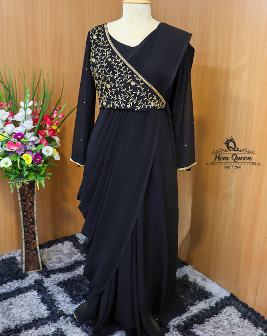 This Overlapping Draped Maxi Dress is a stunning blend of modern elegance and traditional charm. Crafted from rich, flowy fabric, the gown features a unique overlapping drape, full-length sleeves, and delicate gold embroidery that adds a touch of royalty. Perfect for evening parties, festive gatherings, or formal occasions.

Designed for women who want to make a graceful yet bold statement.

Highlights:

Elegant black shade with golden embroidery

Overlapping draped silhouette for a flattering fit

Full-len